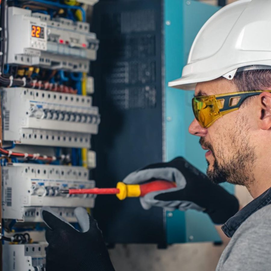 imgi_184_man_an_electrical_technician_working_in_switchboard_with_fuses_8157a61d86